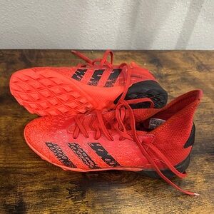 Men’s size 4 orange, red and Black soccer cleats